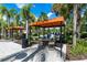 A shady cabana with table and chairs, providing a comfortable spot to relax by the pool at 7587 Oakmoss Loop, Davenport, FL 33837