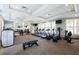 A modern gym with large windows, state-of-the-art equipment, and plenty of natural light for a healthy workout at 7587 Oakmoss Loop, Davenport, FL 33837