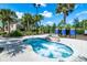 Inviting hot tub surrounded by lush landscaping, providing a serene and relaxing spa experience at 7587 Oakmoss Loop, Davenport, FL 33837