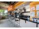 A snack bar featuring a long granite counter with seating, stainless steel appliances, and an open sign at 7587 Oakmoss Loop, Davenport, FL 33837