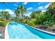 A serene lazy river meandering through lush tropical foliage, providing a peaceful escape for residents at 7587 Oakmoss Loop, Davenport, FL 33837