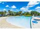 A winding lazy river with crystal-clear water and tropical landscaping, ideal for a relaxing float at 7587 Oakmoss Loop, Davenport, FL 33837