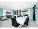 Living room view with a modern chandelier, long white table, and a view of the living room at 7587 Oakmoss Loop, Davenport, FL 33837