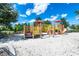 Fun playground with various play structures, climbing areas, and slides, set in a safe and sandy environment at 7587 Oakmoss Loop, Davenport, FL 33837