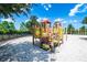 Colorful playground with climbing structures, slides, and a safe, sandy play area at 7587 Oakmoss Loop, Davenport, FL 33837