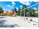 Community playground featuring a slide, swings, and climbing structure on a white sand base at 7587 Oakmoss Loop, Davenport, FL 33837