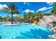 Resort-style pool with a water slide and waterfall feature, perfect for Gathering fun in the sun at 7587 Oakmoss Loop, Davenport, FL 33837