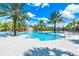 Resort-style pool with waterslide, lush landscaping, and ample seating, offering a fun and relaxing experience for all ages at 7587 Oakmoss Loop, Davenport, FL 33837