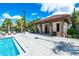 Poolside restrooms with brick and stone accents, offering convenient facilities amidst lush tropical landscaping at 7587 Oakmoss Loop, Davenport, FL 33837