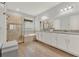 Bright bathroom featuring dual sinks, tub, and a tiled glass shower at 8330 Vivaro Isle Way, Windermere, FL 34786