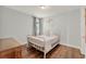 Bedroom with hardwood floors featuring white bedroom set with a dresser and neutral colored walls at 8330 Vivaro Isle Way, Windermere, FL 34786