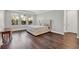 Bedroom featuring hardwood floors, neutral walls, and natural light from three windows at 8330 Vivaro Isle Way, Windermere, FL 34786