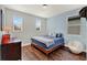 Cozy bedroom featuring wood floors, a wooden bed frame, and neutral colored walls at 8330 Vivaro Isle Way, Windermere, FL 34786