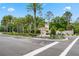 Gated community entrance with tropical landscaping and signage at 8330 Vivaro Isle Way, Windermere, FL 34786