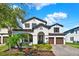 Beautiful two-story home featuring a well-maintained lawn, attached two-car garage, and manicured landscaping at 8330 Vivaro Isle Way, Windermere, FL 34786