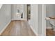 Bright foyer featuring wood flooring, a view of the front door, a glimpse into other rooms, and a half bathroom at 8330 Vivaro Isle Way, Windermere, FL 34786