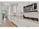 Bright kitchen featuring stainless steel appliances, white cabinetry, and subway tile backsplash at 8330 Vivaro Isle Way, Windermere, FL 34786