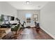 Home office featuring a desk with dual monitors, a Peloton bike, and wood floors at 8330 Vivaro Isle Way, Windermere, FL 34786