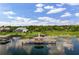 Expansive waterfront property featuring a dock with gazebo, lush greenery, and a beautiful residence at 8814 Southern Breeze Dr, Orlando, FL 32836