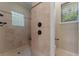 Modern bathroom featuring tiled shower with seat, glass block window, and updated fixtures at 8814 Southern Breeze Dr, Orlando, FL 32836