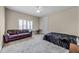 Neutral bedroom with a dark leather couch, desk, and large bed featuring a black fur-like blanket at 8814 Southern Breeze Dr, Orlando, FL 32836