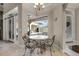 Cozy breakfast nook with wrought iron table set offering views of the screened patio and pool area at 8814 Southern Breeze Dr, Orlando, FL 32836