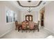 Formal dining area with decorative ceilings, natural light, and a beautiful table set at 8814 Southern Breeze Dr, Orlando, FL 32836