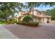 Spacious driveway leading to a well-maintained home with a terracotta roof and attached garage at 8814 Southern Breeze Dr, Orlando, FL 32836