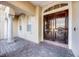 Elegant home entrance with large double doors, classic columns, brick walkway, and lush landscaping at 8814 Southern Breeze Dr, Orlando, FL 32836