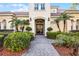 Elegant home featuring a tile roof, manicured landscaping, and a grand entrance with double doors at 8814 Southern Breeze Dr, Orlando, FL 32836