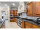 Elegant kitchen featuring dark wood cabinets, stainless steel appliances, and granite countertops at 8814 Southern Breeze Dr, Orlando, FL 32836