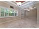 Elegant living room featuring plantation shutters, tray ceiling, and marble floors at 8814 Southern Breeze Dr, Orlando, FL 32836