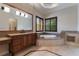 Large main bathroom with soaking tub, double vanity, marble floors and countertops at 8814 Southern Breeze Dr, Orlando, FL 32836