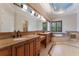 Luxurious bathroom features double vanities, a soaking tub, and designer lighting at 8814 Southern Breeze Dr, Orlando, FL 32836