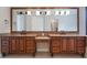 Beautiful bathroom boasting double vanities, granite countertops, and generous lighting at 8814 Southern Breeze Dr, Orlando, FL 32836
