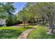 Community playground with mature shade trees and lush landscaping at 8814 Southern Breeze Dr, Orlando, FL 32836