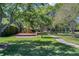 Community playground with mature shade trees and lush landscaping at 8814 Southern Breeze Dr, Orlando, FL 32836