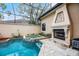 Screened pool and spa with a fireplace and stone deck, creating a relaxing outdoor oasis at 8814 Southern Breeze Dr, Orlando, FL 32836