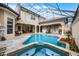 Enclosed pool and spa surrounded by a travertine deck and covered lounge areas, creating an inviting outdoor space at 8814 Southern Breeze Dr, Orlando, FL 32836