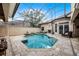 Enclosed swimming pool and spa featuring a fireplace and travertine tile, offering a private outdoor retreat at 8814 Southern Breeze Dr, Orlando, FL 32836