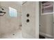 Walk in shower with tile surround and a glass block window at 8814 Southern Breeze Dr, Orlando, FL 32836