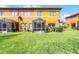 Townhome backyard featuring a patio and lush grass at 9568 Muse Pl, Orlando, FL 32829