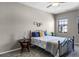 Bedroom featuring modern ceiling fan, large window, and new carpet at 9568 Muse Pl, Orlando, FL 32829