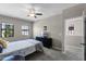 Bedroom boasting modern ceiling fan, large windows, and new carpet at 9568 Muse Pl, Orlando, FL 32829