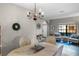 Cozy dining area with wood floors, a decorative chandelier, and neutral decor creating a warm, inviting ambiance at 9568 Muse Pl, Orlando, FL 32829