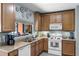 Well-lit kitchen featuring essential appliances, tile floors and ample storage at 9568 Muse Pl, Orlando, FL 32829