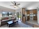 Open living room with tile and wood flooring, connecting the living room and kitchen for easy entertaining at 9568 Muse Pl, Orlando, FL 32829