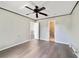 Spacious bedroom features a ceiling fan, wood-look flooring and multiple doorways to other rooms at 10562 Bridlewood Ave, Orlando, FL 32825