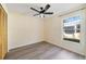 Bedroom with ceiling fan, wood-look flooring, and natural light from the window at 10562 Bridlewood Ave, Orlando, FL 32825