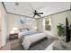 Cozy bedroom with a ceiling fan, natural light, and minimalist decor at 10562 Bridlewood Ave, Orlando, FL 32825